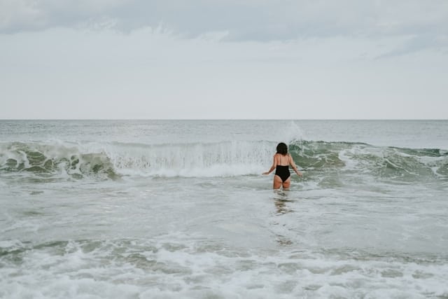 women going to swim in the sea in spring