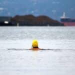 women swimming with swim cap on in cold water