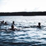 people wild swimming in lake