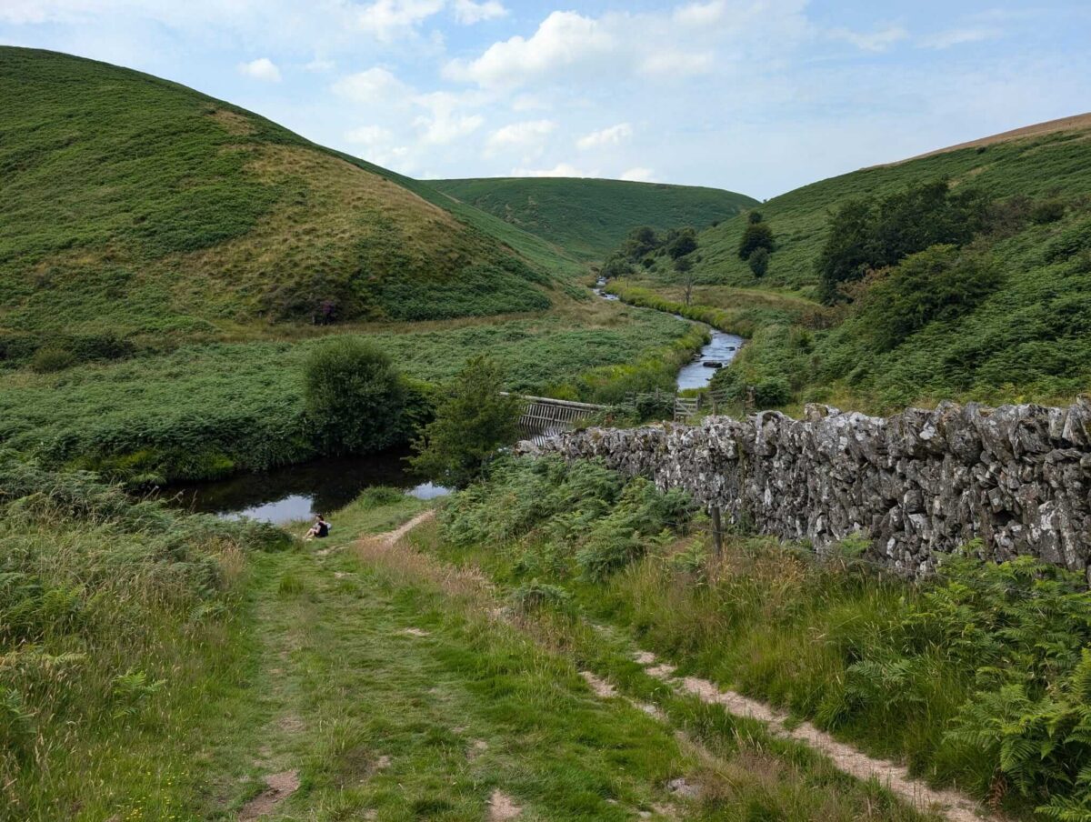 the ruins of Cow Castle looking down on to a wild swimming area on the River Barle 