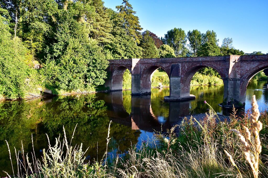 view of the river wye crossing bridge at bredwardine